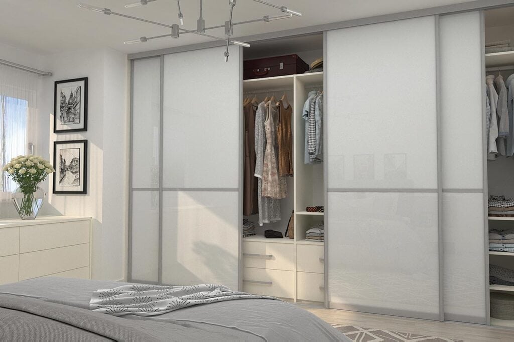 Built-in wardrobe with sliding doors for organized storage in bedroom.