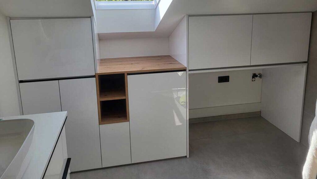 Modern bathroom cabinetry with wooden countertop and storage solutions.