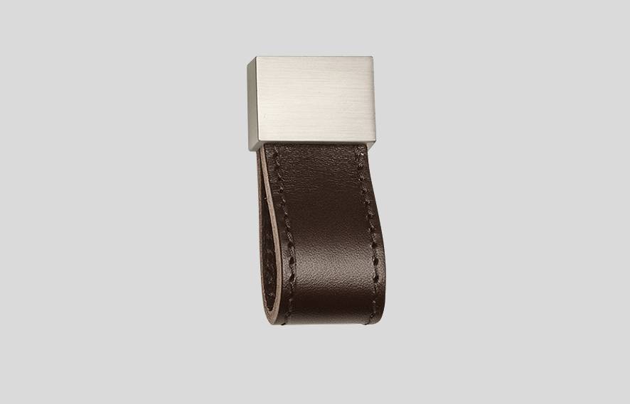 Leather and metal furniture leg for stylish home interiors.