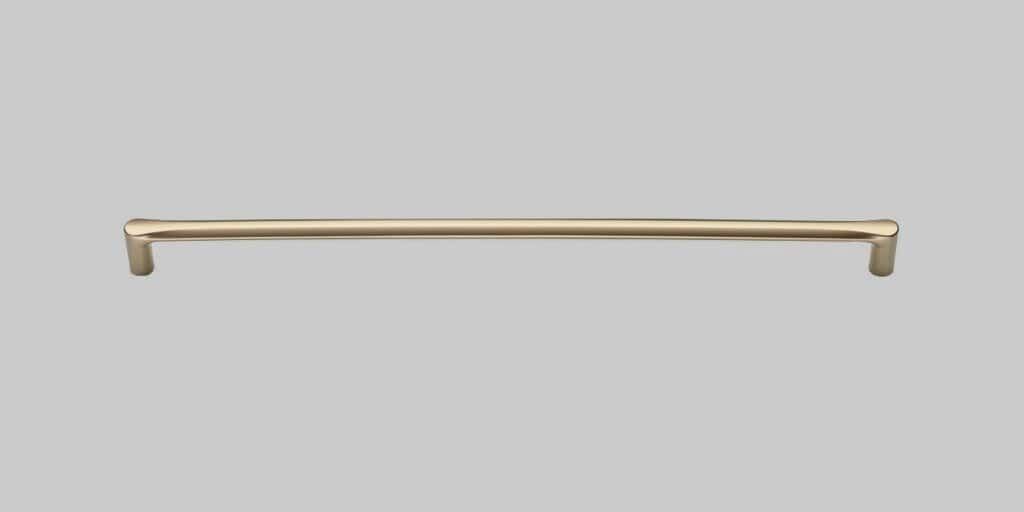 Handle for furniture doors and drawers in a sleek, gold finish.