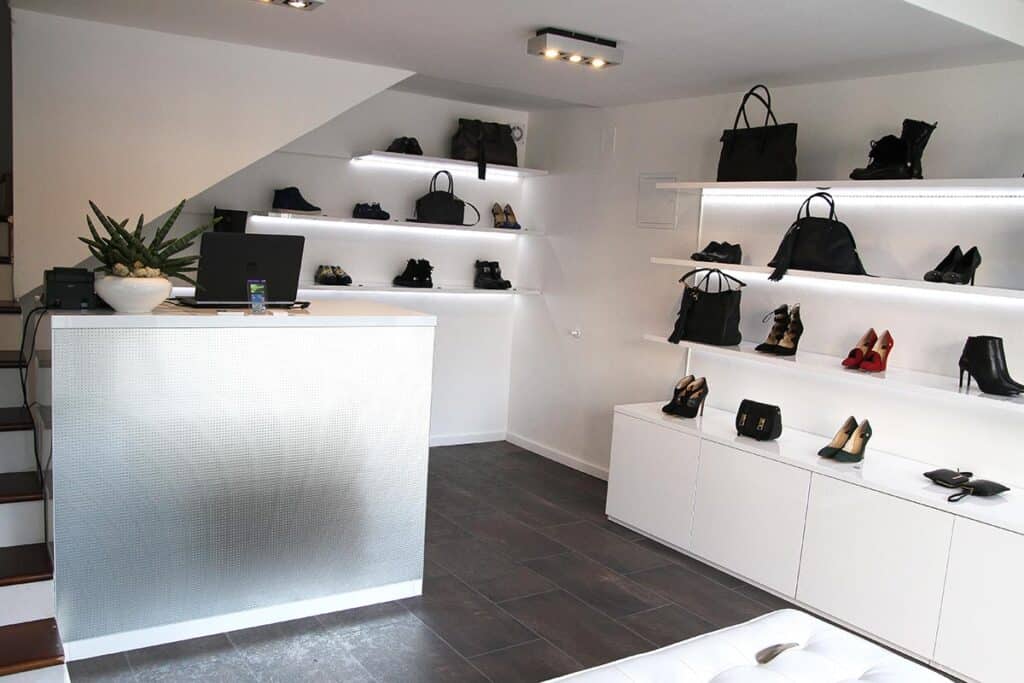 Office storage and display shelves with handbags and shoes.
