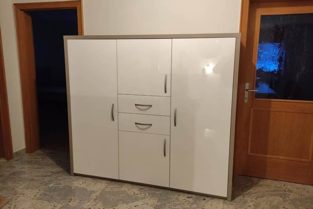 White wardrobe with storage space for shoes, coats, and accessories.